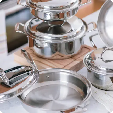 set of stainless steel cookware on a kitchen counter